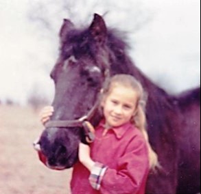 girl with pony. Love of horses starts early in life